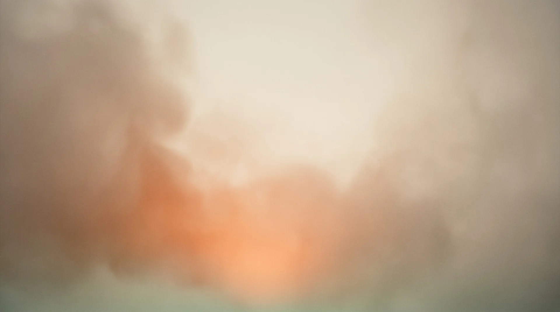 Warm dissolved infusion — ember light blooming up through atmospheric haze