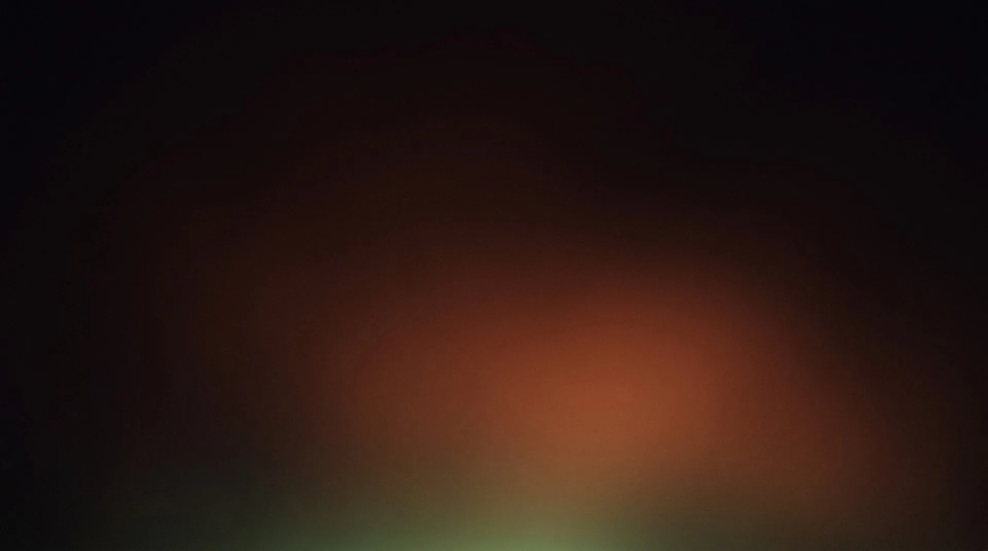 Embers glowing up through deep dark with a faint moss-green renewal at the base — the cycle completing